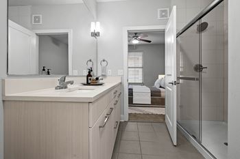 A bathroom with a white sink and a mirror above it. at 46 Penn Apartment Homes, Kansas City, 64111